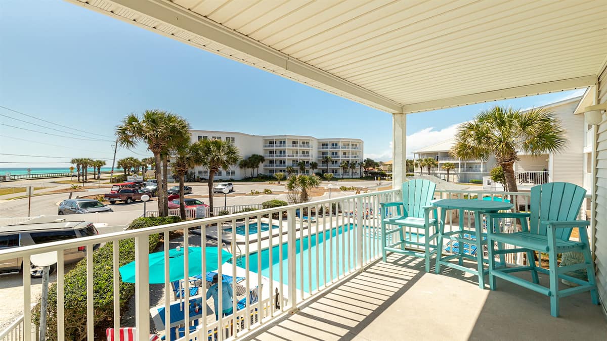 Turquoise balcony chairs with views of the pool and Gulf